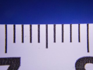 TG-6 filling the frame with 1cm of tape, at about 1-2cm from the tape. Some chromatic aberration can be noted at the periphery.